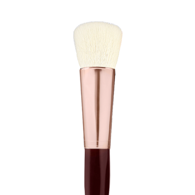 A face blending brush with cream-coloured bristles with a rose-gold and dark crimson handle. 