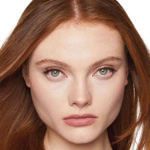 Close-up of a fair-tone model with green eyes wearing natural, dewy makeup. 