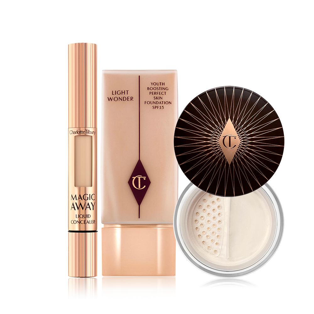 Cream concealer in a rose gold tube, primer in a clear bottle with a rose gold-coloured lid, and finishing powder in a glass jar with a dark brown-coloured lid. 