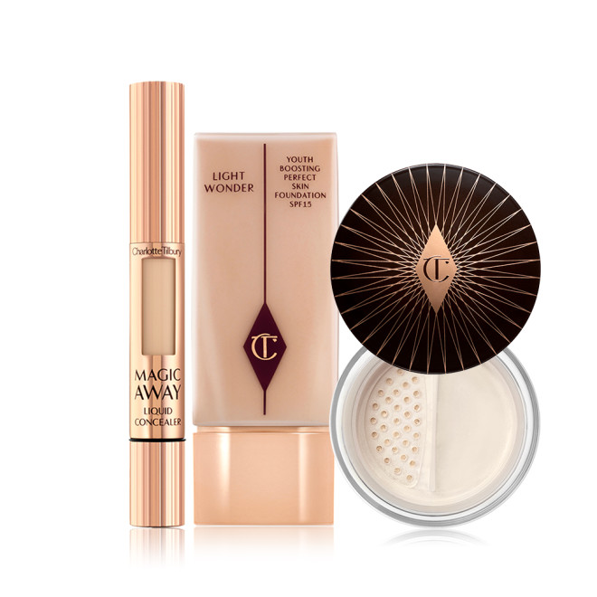 Cream concealer in a rose gold tube, primer in a clear bottle with a rose gold-coloured lid, and finishing powder in a glass jar with a dark brown-coloured lid. 