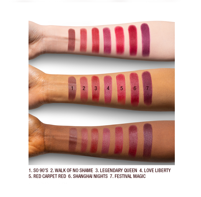 Arm swatches on fair, medium, and dark tone models of matte lipsticks in shades of red, plum, and burgundy. 