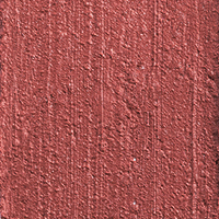 Swatch of a lip and cheek colour stick in a glowy soft pink shade.