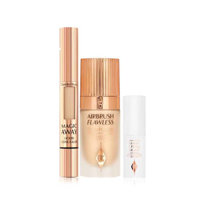 Creamy liquid concealer in a gold-coloured tube with a soft sponge applicator end, foundation in a frosted glass bottle with a gold-coloured lid, and pearly-white face cream in a glass jar with a gold coloured lid.