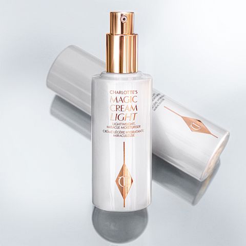 Two face creams in glass bottles, one with a white-coloured lid and the other without with gold-coloured pump dispensers along with the CT logo printed on them. 