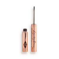 Open, tinted brow gel in a black-brown shade with a thin brush for precision, and a shiny, gold-coloured tube.