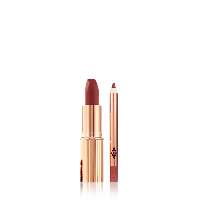 Walk of No Shame Lip Kit open A berry-red lip liner pencil with an open matte lipstick in a berry-rose shade inside a golden-coloured tube.