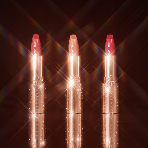 Open packshots of sparkly packaging lipsticks in the shades Nude Talk, Rosy Seduction and Chic Pink. 