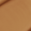 Close-up swatch of a skin-like, glowy foundation in a dark brown shade.