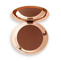 An open mirrored-lid bronzer compact in a dark brown shade. 