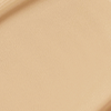 Close-up swatch of a skin-like, glowy foundation in a light, sandy beige shade.