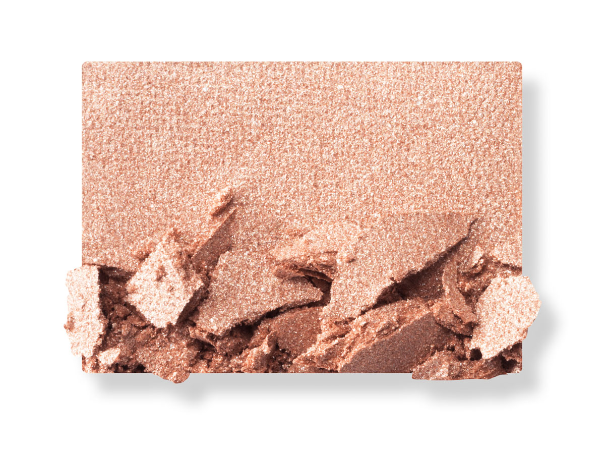 Swatch of a shimmery, powder eyeshadow in a soft, highlighting champagne shade. 