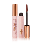 Two tubes of mascara, one with a lid on and one without, in a chocolate-brown-colour with a pink-coloured tube with a gold-coloured lid. 