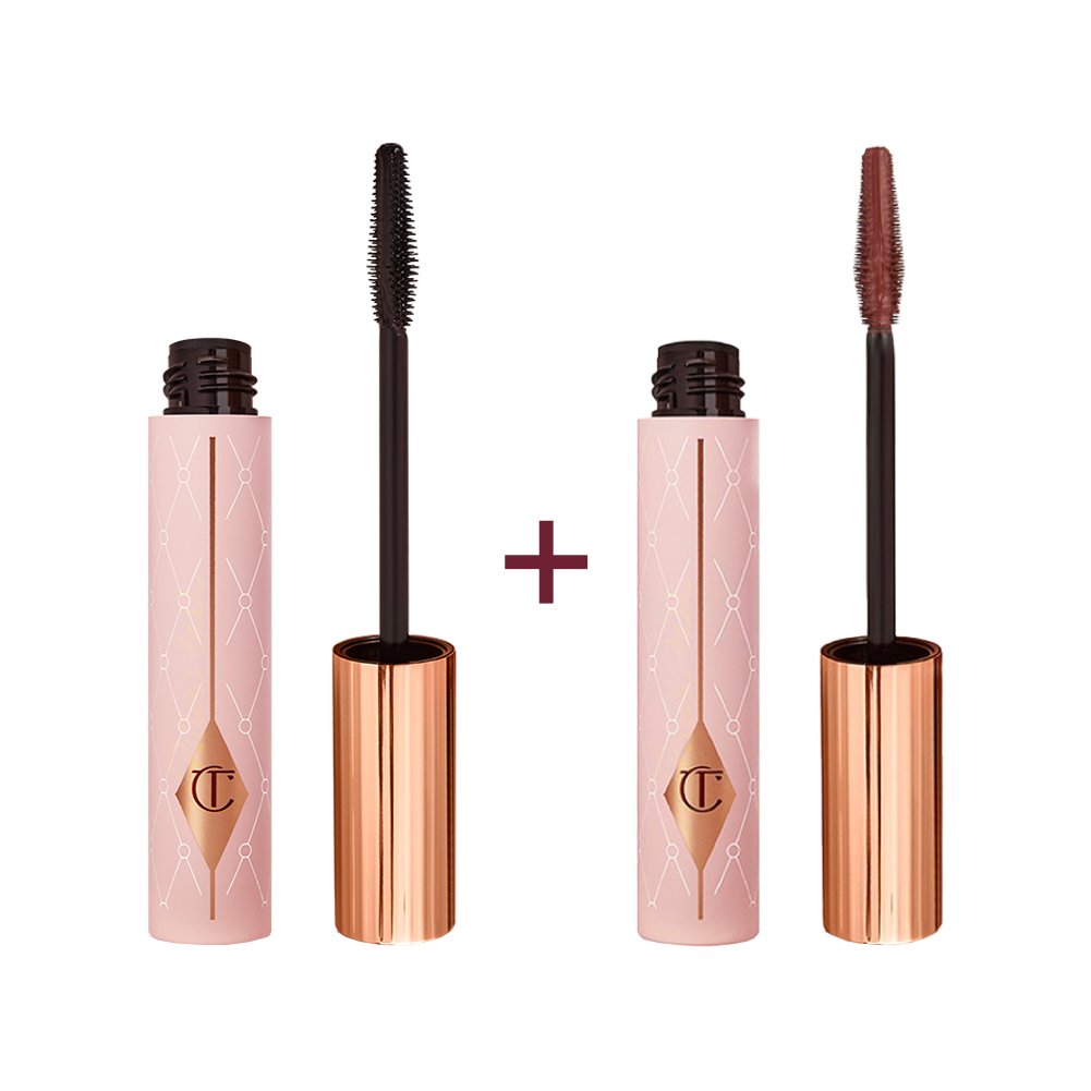 Two tubes of mascara, one with a lid on and one without, in a chocolate-brown-colour with a pink-coloured tube with a gold-coloured lid. 