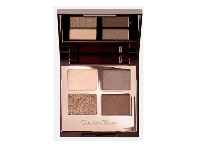 An open, mirrored-lid eyeshadow palette in matte and shimmery gold, brown, and beige shades,