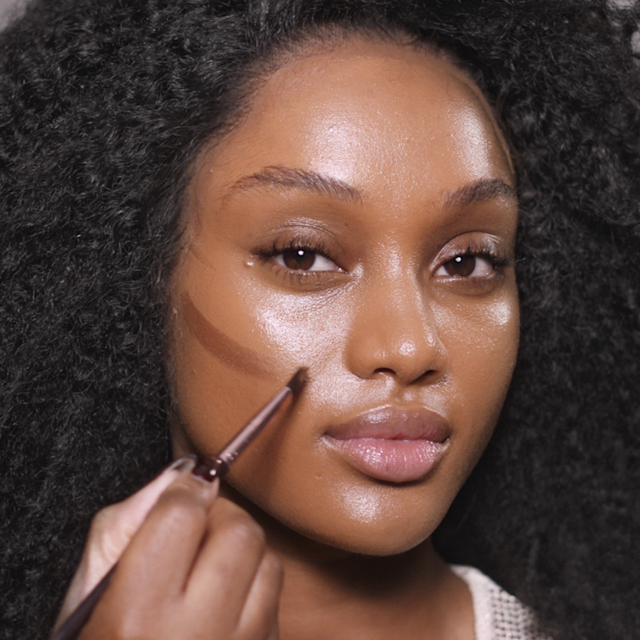Step 1 in Charlotte's 70s makeup tutorial is applying foundation, concealer and bronzer