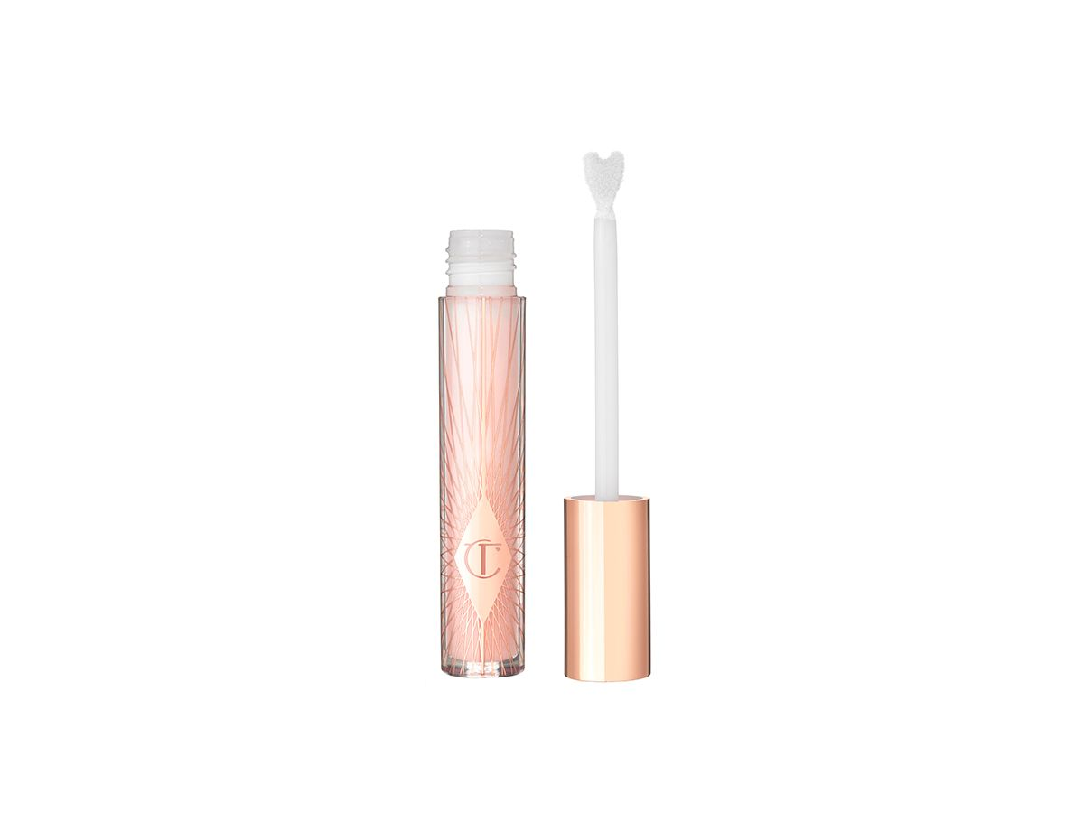 A lip gloss in a sheer pink shade in a glass tube with its heart-shaped applicator next to it.