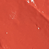 Close-up swatch of a moisturising lipstick balm in a dark coral shade.