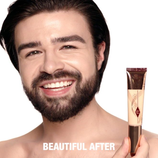 Light-tone male model with glowy, flawless skin with cool undertones, wearing skin-like foundation that adds a youthful glow and looks natural along with nude pink lipstick and subtle everyday eye makeup.