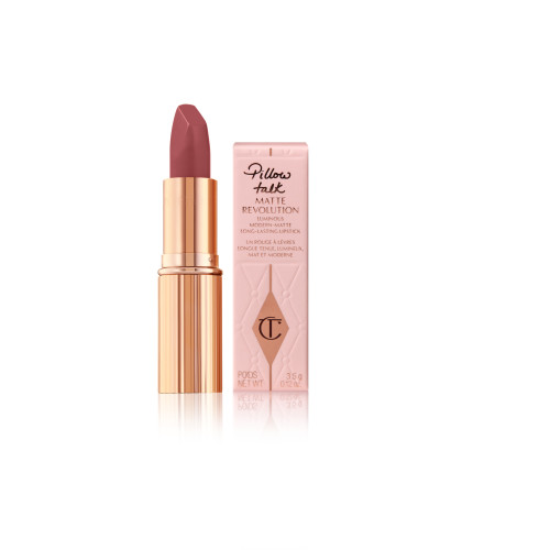 An open, warm berry-pink lipstick in a golden, metallic tube with nude-pink box packaging. 