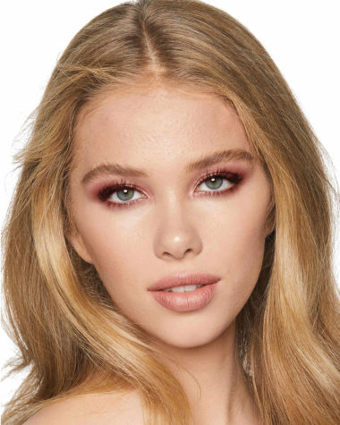 Fair-tone model with grey eyes wearing a dusky rose-pink cream eyeshadow with nude peach matte lipstick. 