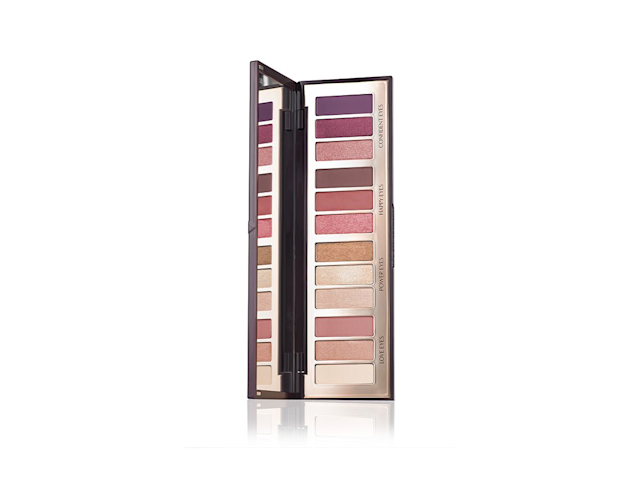 An open, mirrored-lid eyeshadow palette in matte and shimmery brown, pink, gold, purple, and nude shades. 