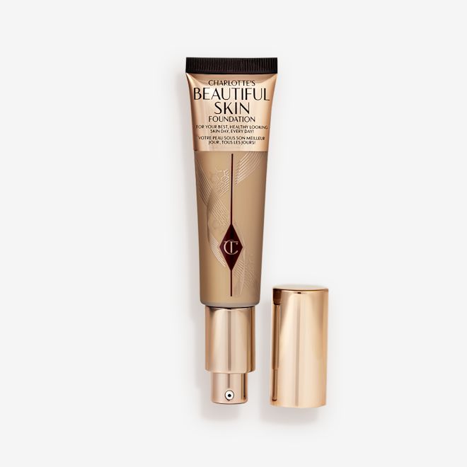 Beautiful Skin Foundation in Shade 7N open An open foundation wand in gold packaging with a pump dispenser and a medium-brown-coloured body to show the shade of the foundation inside.