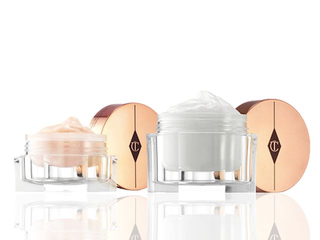 A pearly-white face cream in a large, glass jar with a  champagne-coloured eye cream in a petite glass jar, both with their rose-gold metallic lids removed