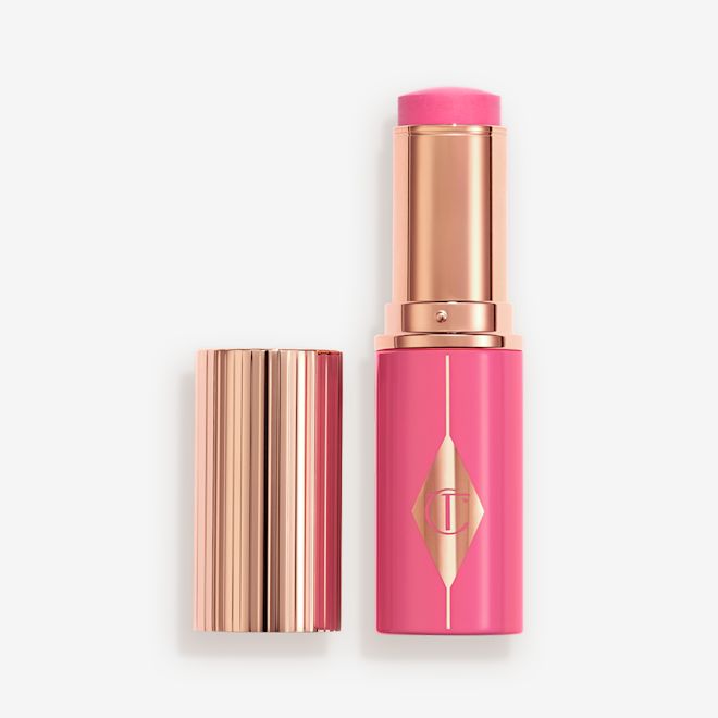 Unreal Blush PinkyGlow Open Packshot Pink packaging matching to the stick product with a rose gold lid and detailing.