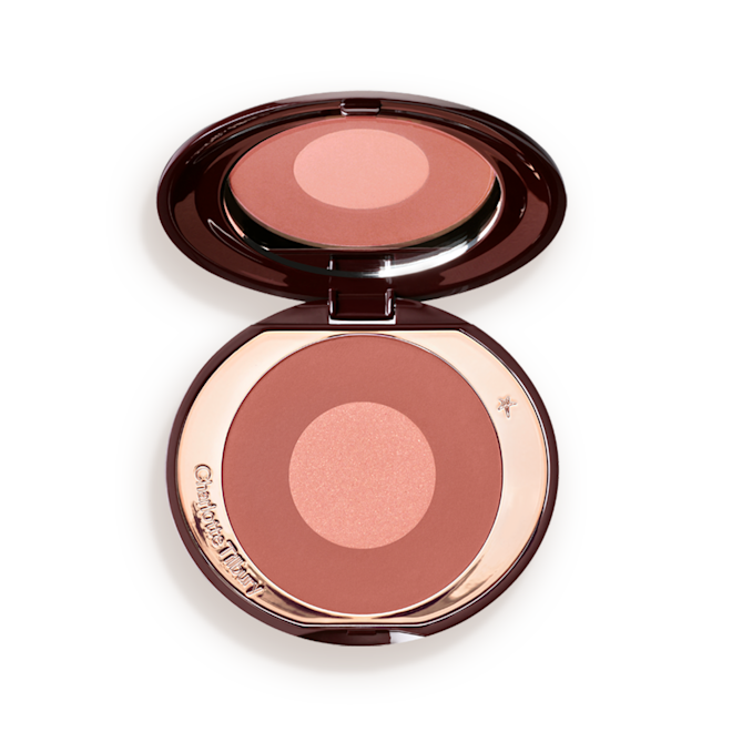 Cheek To Chic Pillow Talk Intense lid opened An open, two-tone, round blush with a pinky-brown outer circle and rose gold centre, encased in a metallic, rose gold case with a mirror inside the lid.