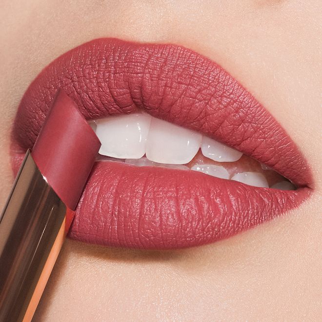 Limitless Lucky Lips in everlasting bloom on lips close-up Lips close-up of a fair-tone model wearing dusty rose lipstick with a matte finish.