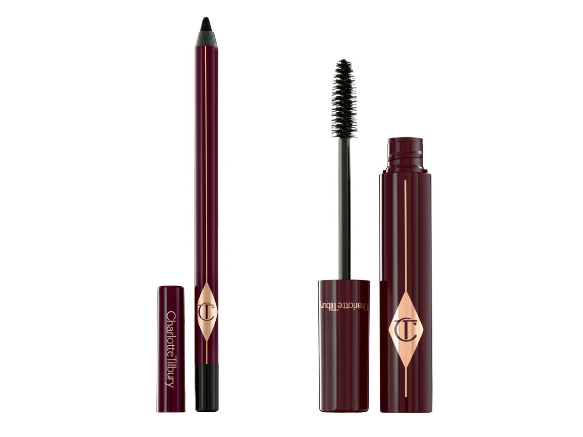 An open, black eyeliner pencil with its cap next to it with a black mascara with its applicator next to it. 