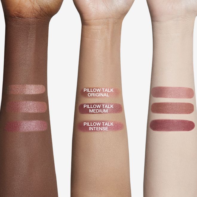 Pillow Talk Matte Revolution arm swatches Deep-tone, tan, and fair-tone arms with swatches of three matte lipsticks in nude pink, brown-pink, and dark berry-pink.