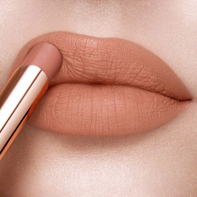 Lips close-up of a fair-tone model wearing a soft taupe lipstick with a matte finish.