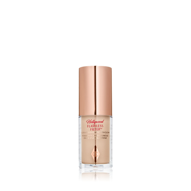 A closed glow-boosting primer in a glass bottle with a rose gold-coloured lid. 
