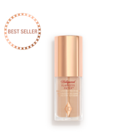 A closed glow-boosting primer in a glass bottle with a rose gold-coloured lid. 