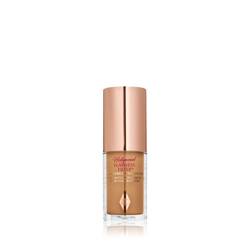 A mini luminous primer in a medium-dark shade in a glass bottle with a gold-coloured lid. 