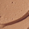 Swatch of a hydrating cream bronzer in a light-sandy-brown shade.