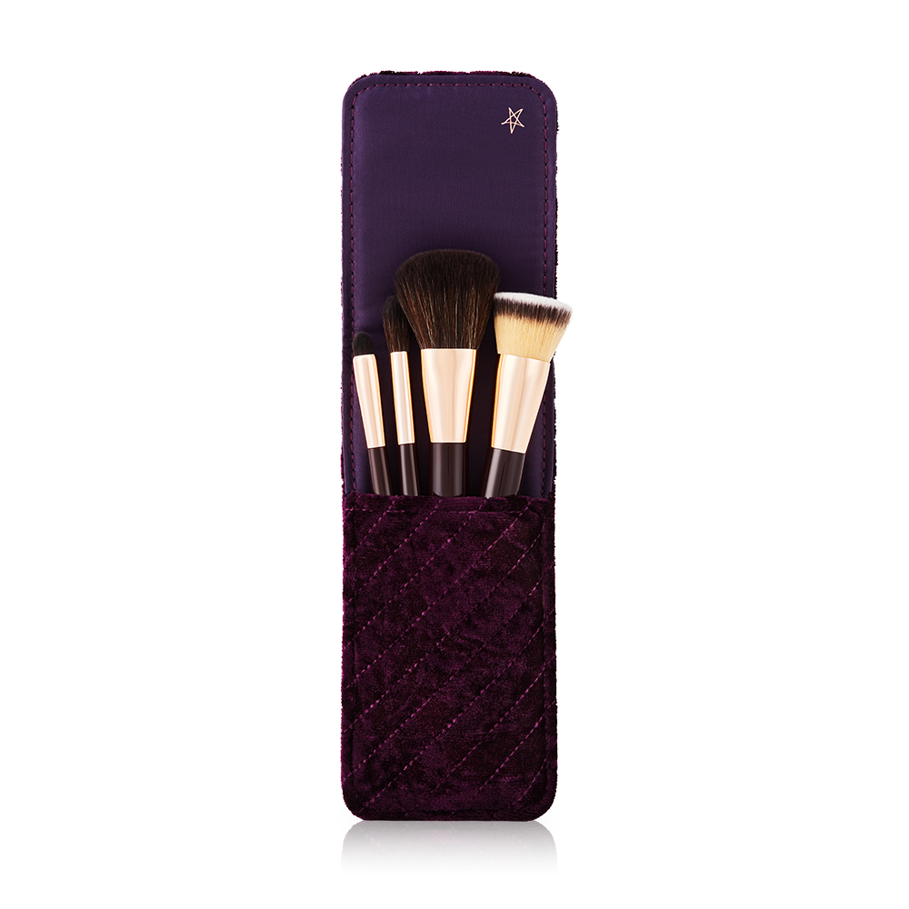 An open makeup clutch brush gift set in brown colour, which includes a foundation brush, powder brush, an eyeshadow brush, and bronzing brush. 