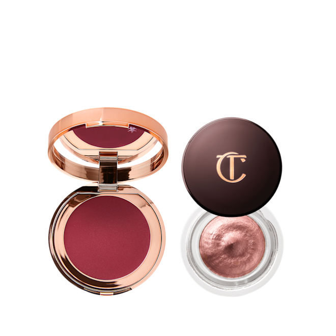 Dreamy Glowing Eye, Lip & Cheek Kit open A berry-pink lip and cheek cream tint compact with a mirrored-lid with an open cream eyeshadow in a glass pot in a rose gold colour.