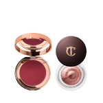 A berry-pink lip and cheek cream tint compact with a mirrored-lid with an open cream eyeshadow in a glass pot in a rose gold colour. 