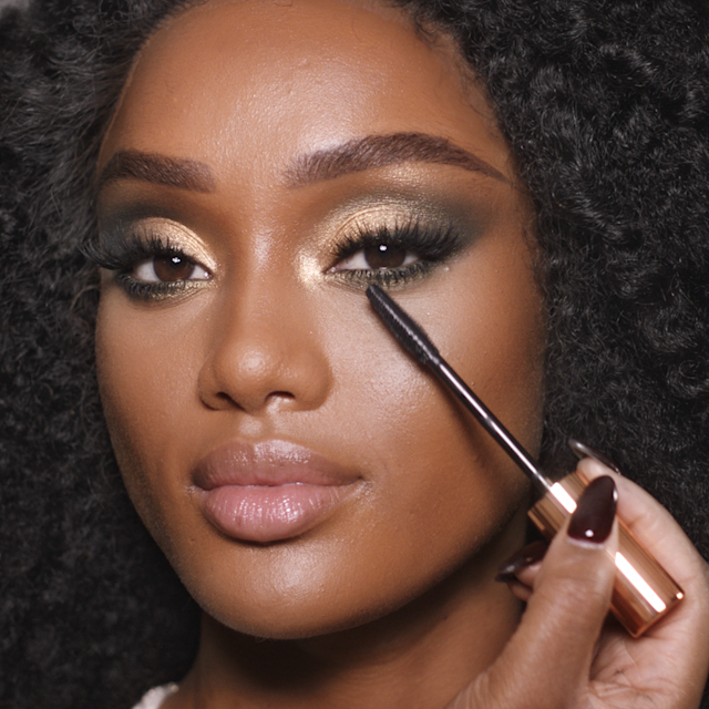 Step 8 in Charlotte's 70s makeup tutorial is to apply mascara to create stretched-looking 70s lashes
