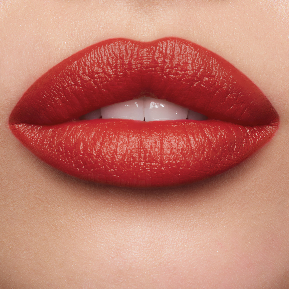 Lip close up of Fame Flame fire red Matte Revolution lipstick