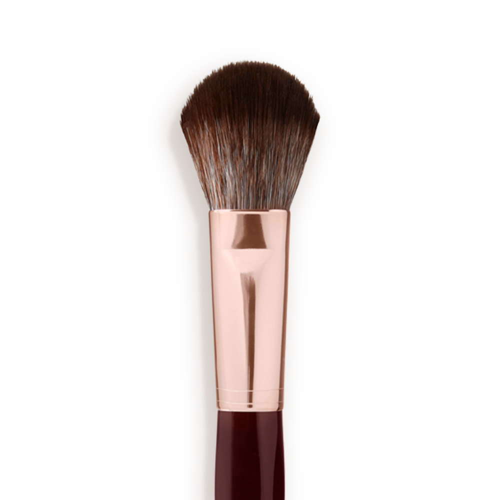 Close-up of a bronzer and blush brush with dark brown and grey bristles with a rose-gold and dark crimson handle. 
