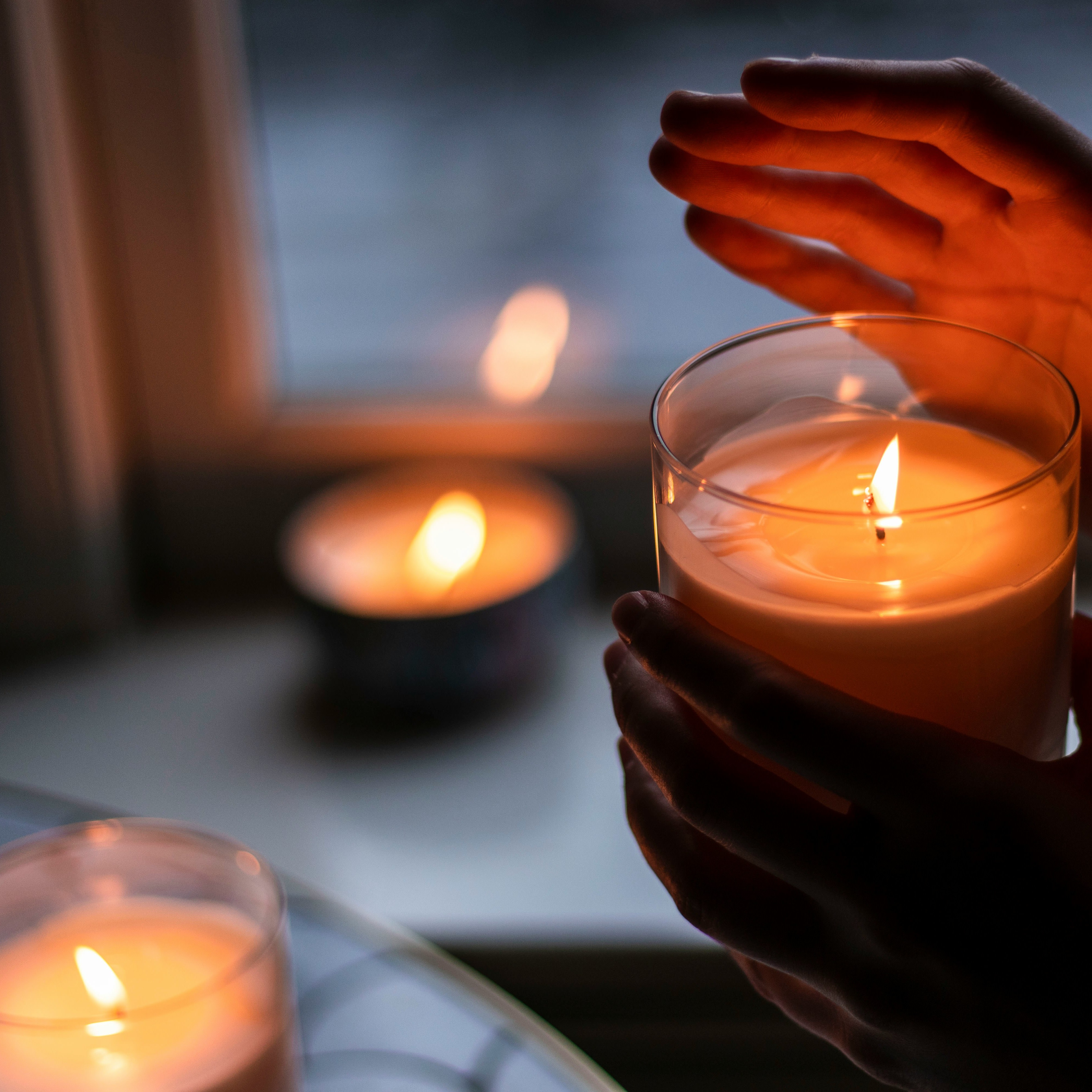 Person lighting a candle to set their intentions