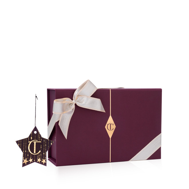 A maroon-coloured gift box with the CT logo printed on it, and the box adorned with a silver satin ribbon tied across with a bow on the top.