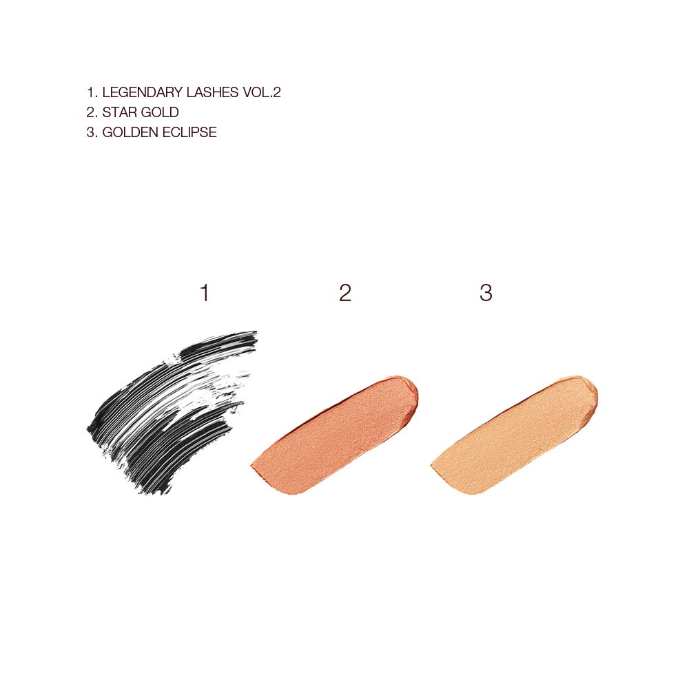 Swatches of black mascara and two cream eyeshadows in rose gold and warm gold shades.