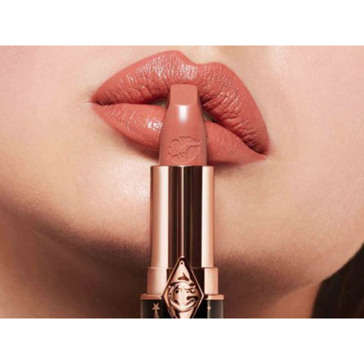 Model wearing Hot Lips 2 lipstick in shade JK Magic, a nude-pink that's flattering on fair skin