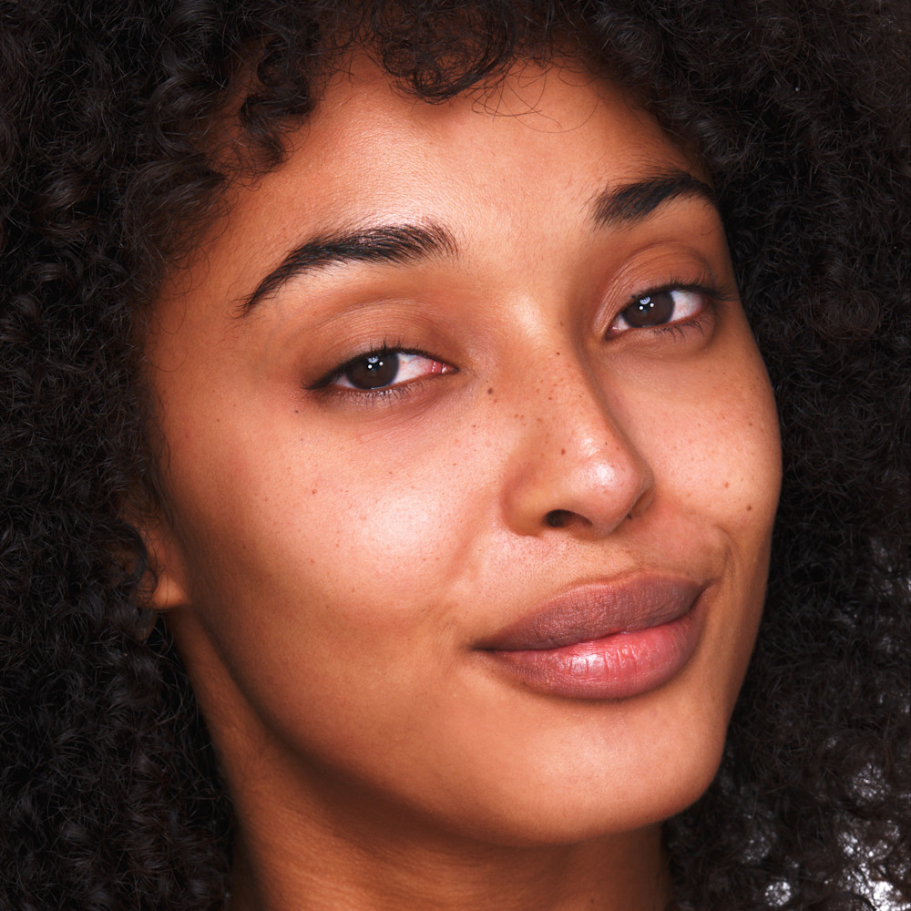 Model without makeup before creating their minimal makeup look