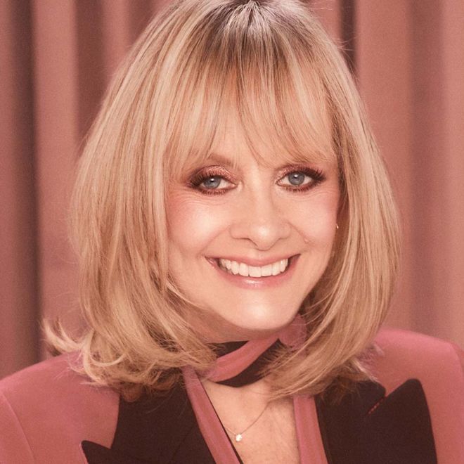 Pillow Talk Just Kissed Glow Kit on fair-tone model with mature skin Fair-tone model with mature skin and blue eyes wearing nude pink matte lipstick with shimmery rose gold eye makeup and soft nude pink, glowy blush.