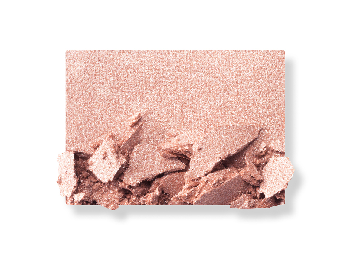 Swatch of a shimmery powder eyeshadow in a pinkish-beige shade. 